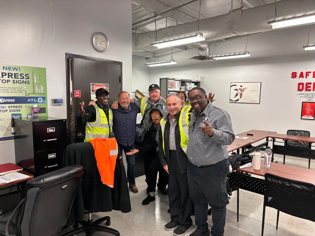 Bill Parsons with transit facility staff outside a regional transit office