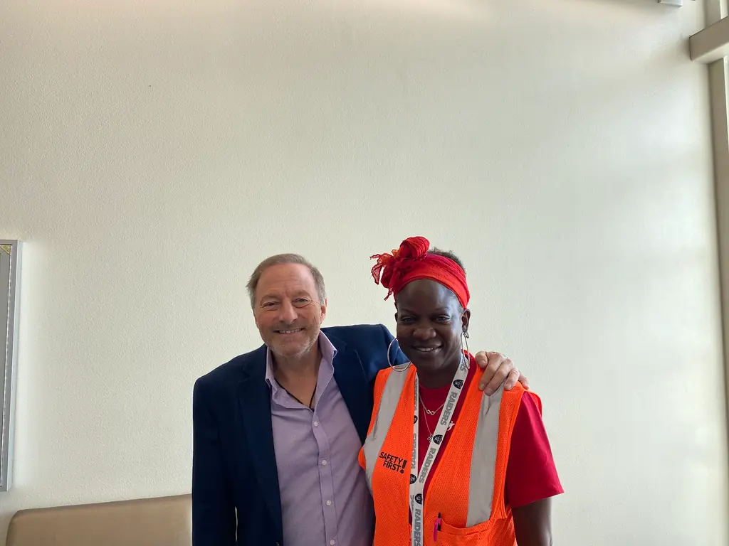 Bill Parsons with a client wearing a safety marked event staff vest
